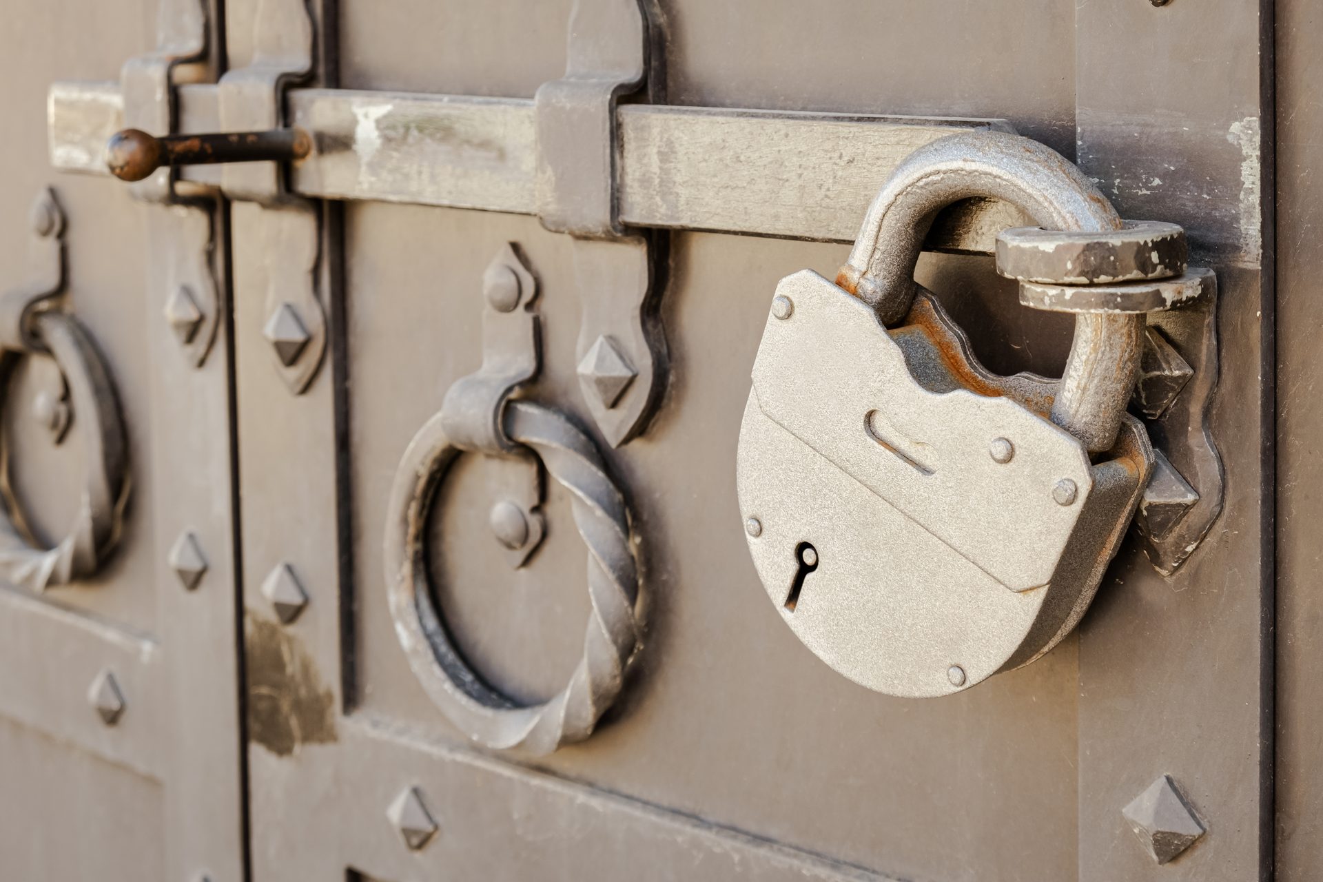 An antique lock on a heavy metal door